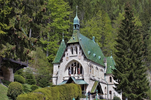 A serene view of the synagogue exterior surrounded by greenery.