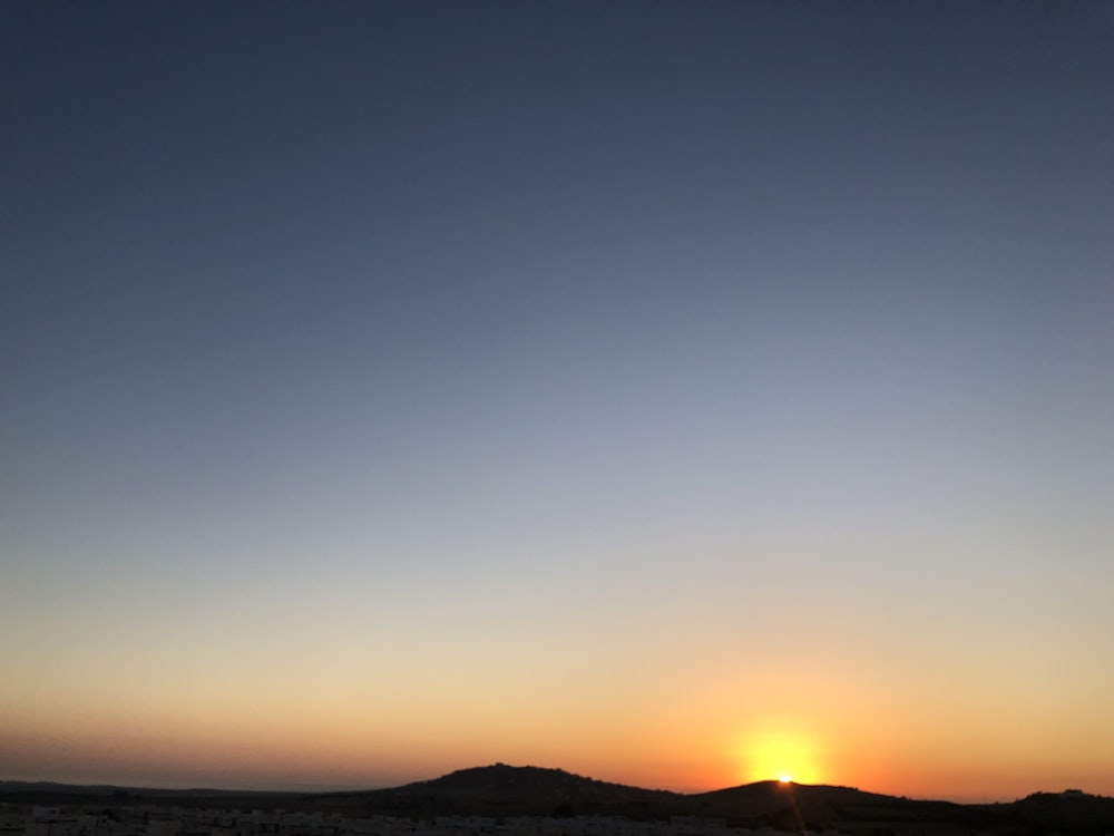 silhouette of mountain during golden hour