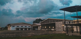 A spacious yellow metal hangar under a clear sky in Abidjan.