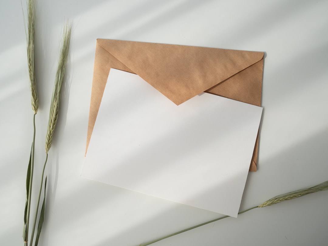 white invitation and envelope on a table.