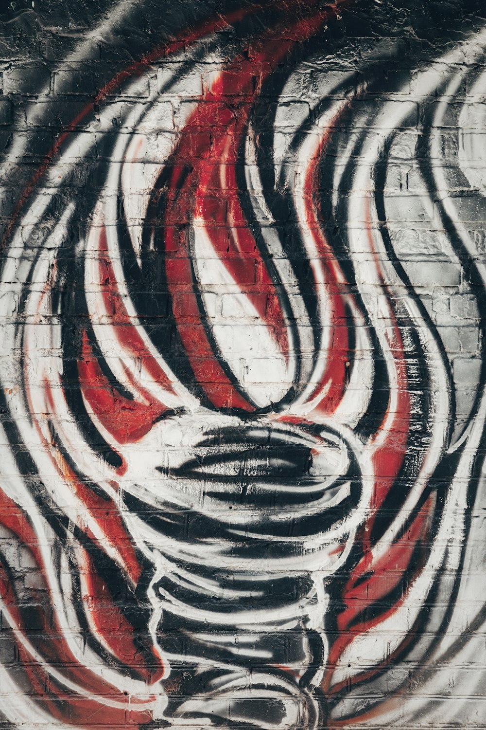 gray, red and black graffiti on a wall