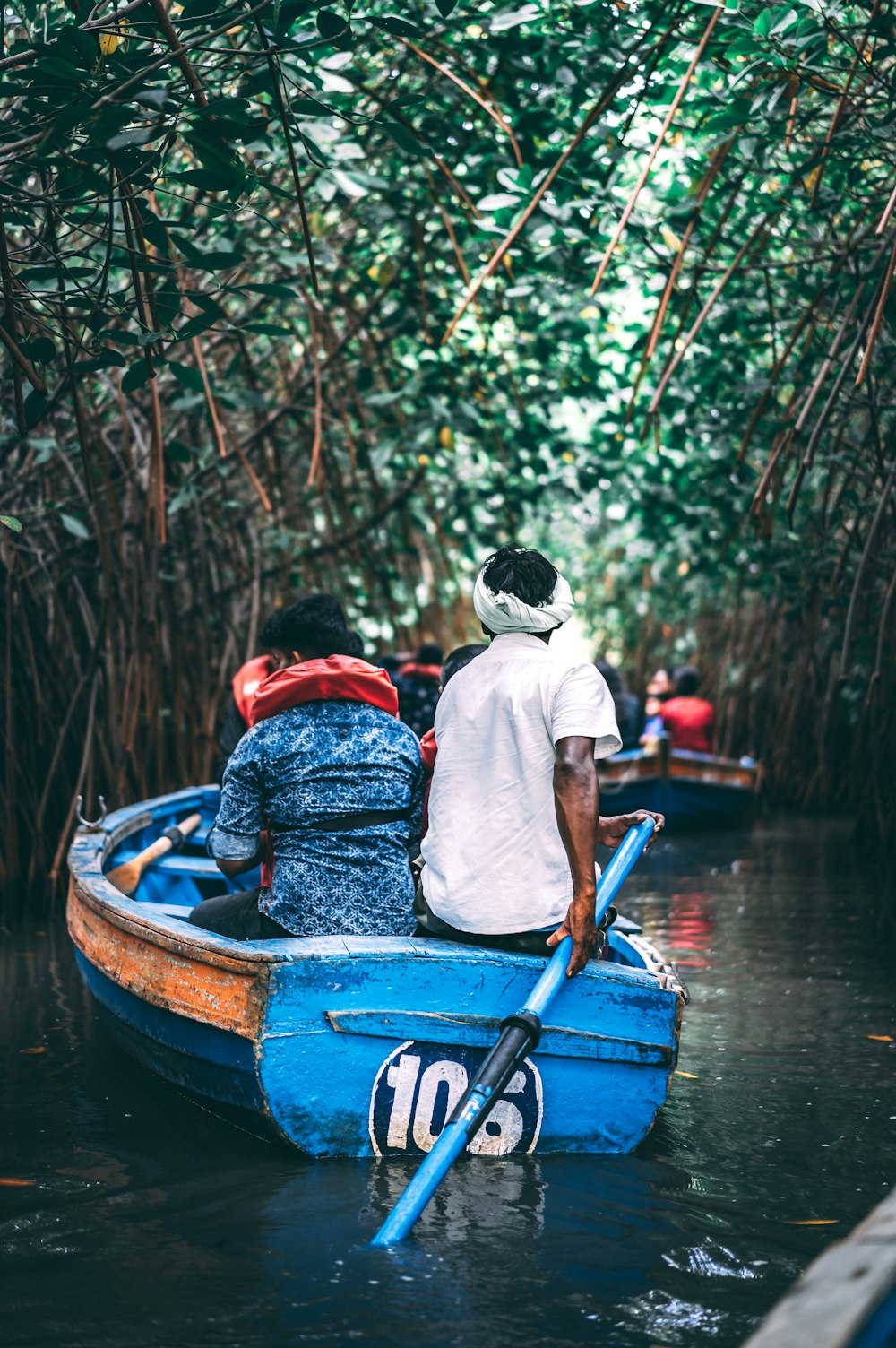 shallow focus photo of person riding paddle boat during daytime