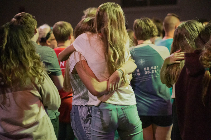 Friends hugging at a youth event