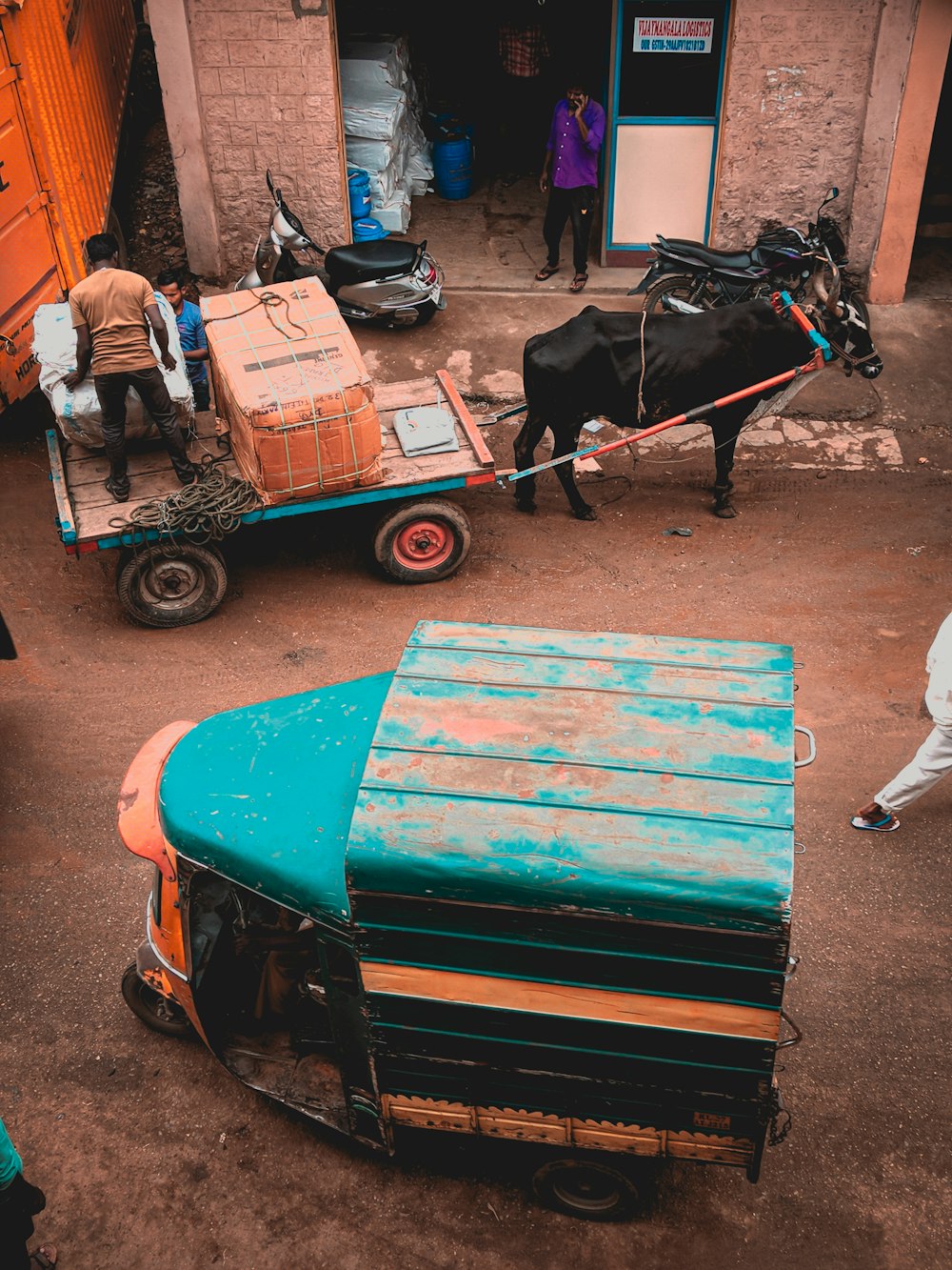 blue and black auto rickshaw beside horse carriage