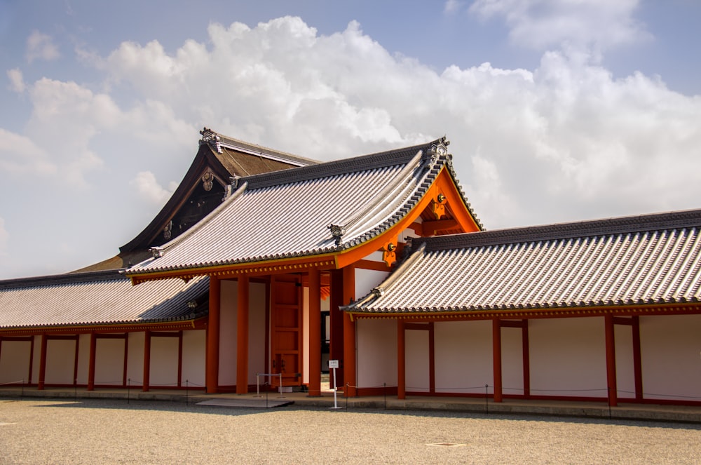 white and brown building under white clouds