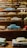 A collection of miniature cars displayed on a shelf.