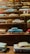 An array of vintage car models displayed on a wooden shelf, showcasing their intricate details.