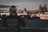 man looking at city skyline from a terrace during nighttime