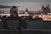 man looking at city skyline from a terrace during nighttime