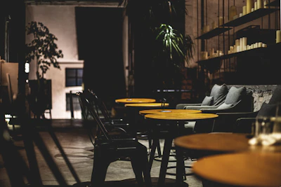 A cozy restaurant corner with matte forest green walls and glowing candles creating an inviting atmosphere.