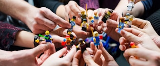 people holding miniature figures