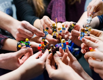 people holding miniature figures