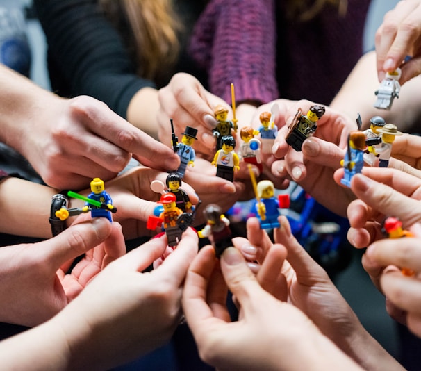 people holding miniature figures