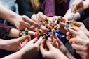 people holding miniature figures