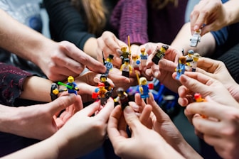 people holding miniature figures