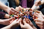 people holding miniature figures