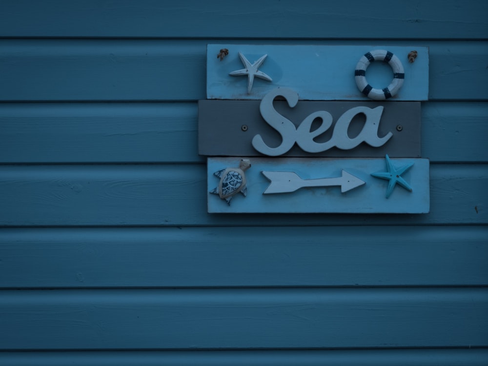 blue and brown sea signboard on wall