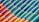 Rows of colorful ceramic tiles installed diagonally. The tiles display a gradient of colors ranging from vibrant orange to deep green. Each tile has a glossy finish, reflecting light in a playful manner.