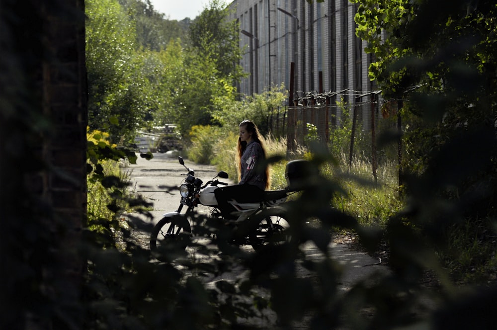 woman sitting on parked motorcycle