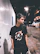 Young person confidently wearing a bold nogxus t-shirt in an urban nighttime setting.