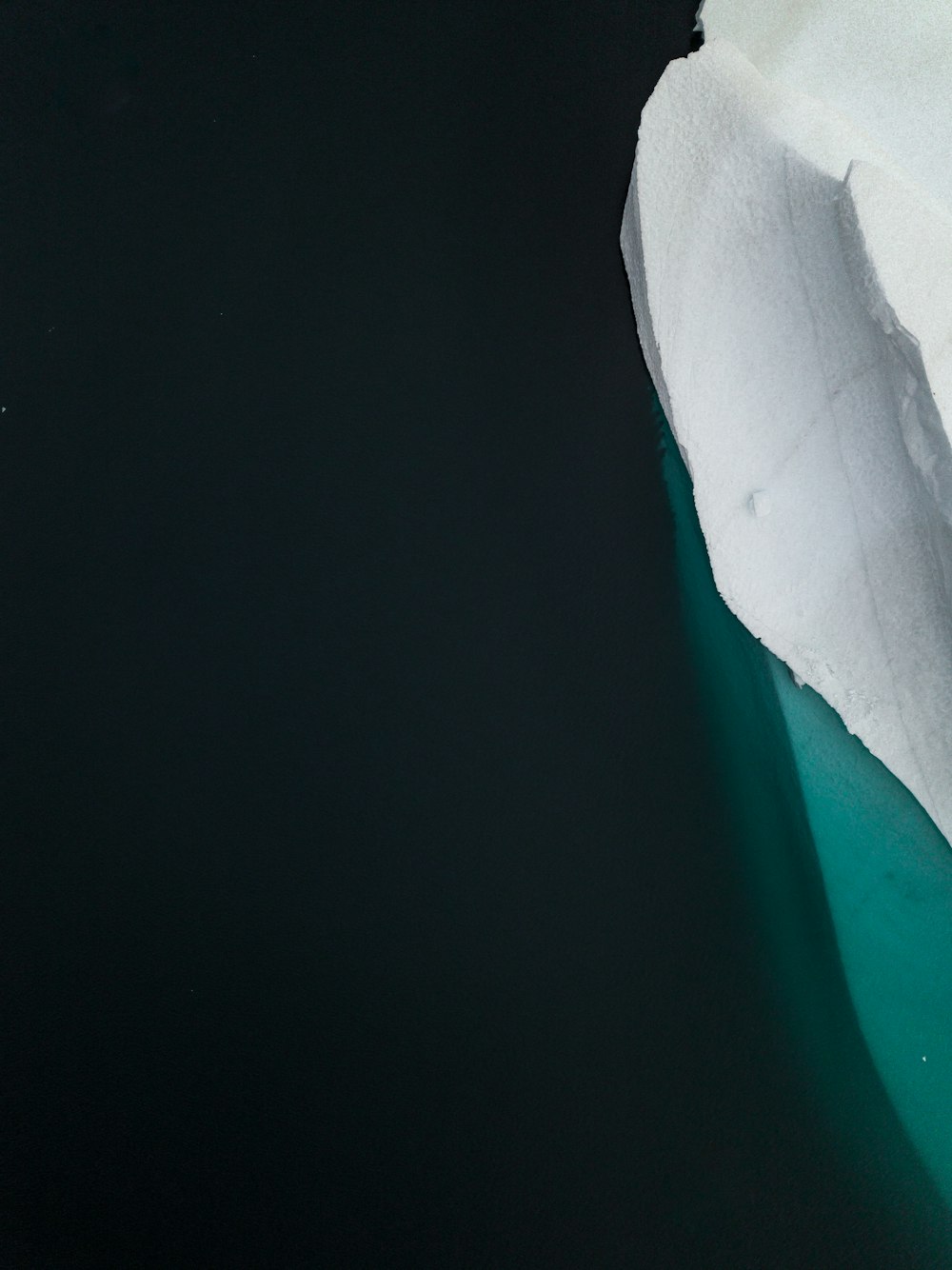 an iceberg floating in the water near a glacier