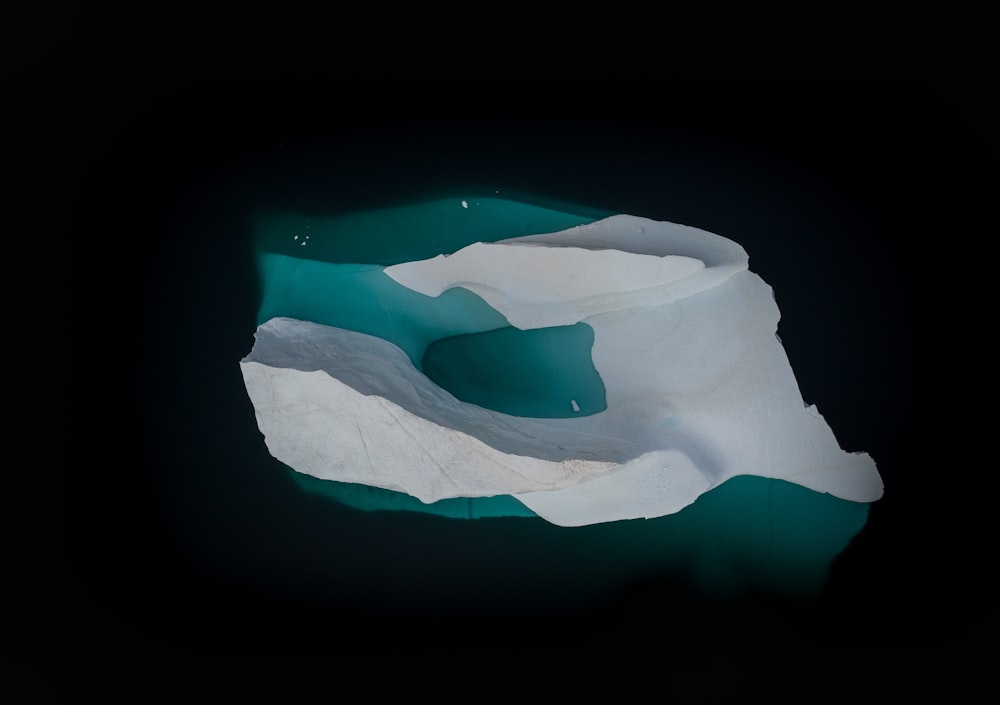 an aerial view of an iceberg in the water