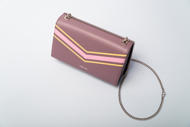 A stylish tote bag displayed on a pastel-colored background.