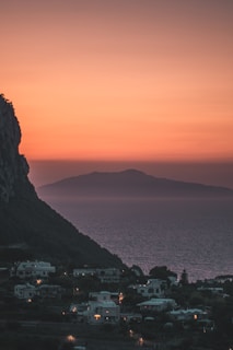 a sunset view of a town and the ocean