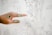 a person's hand pointing at a drawing on a wall