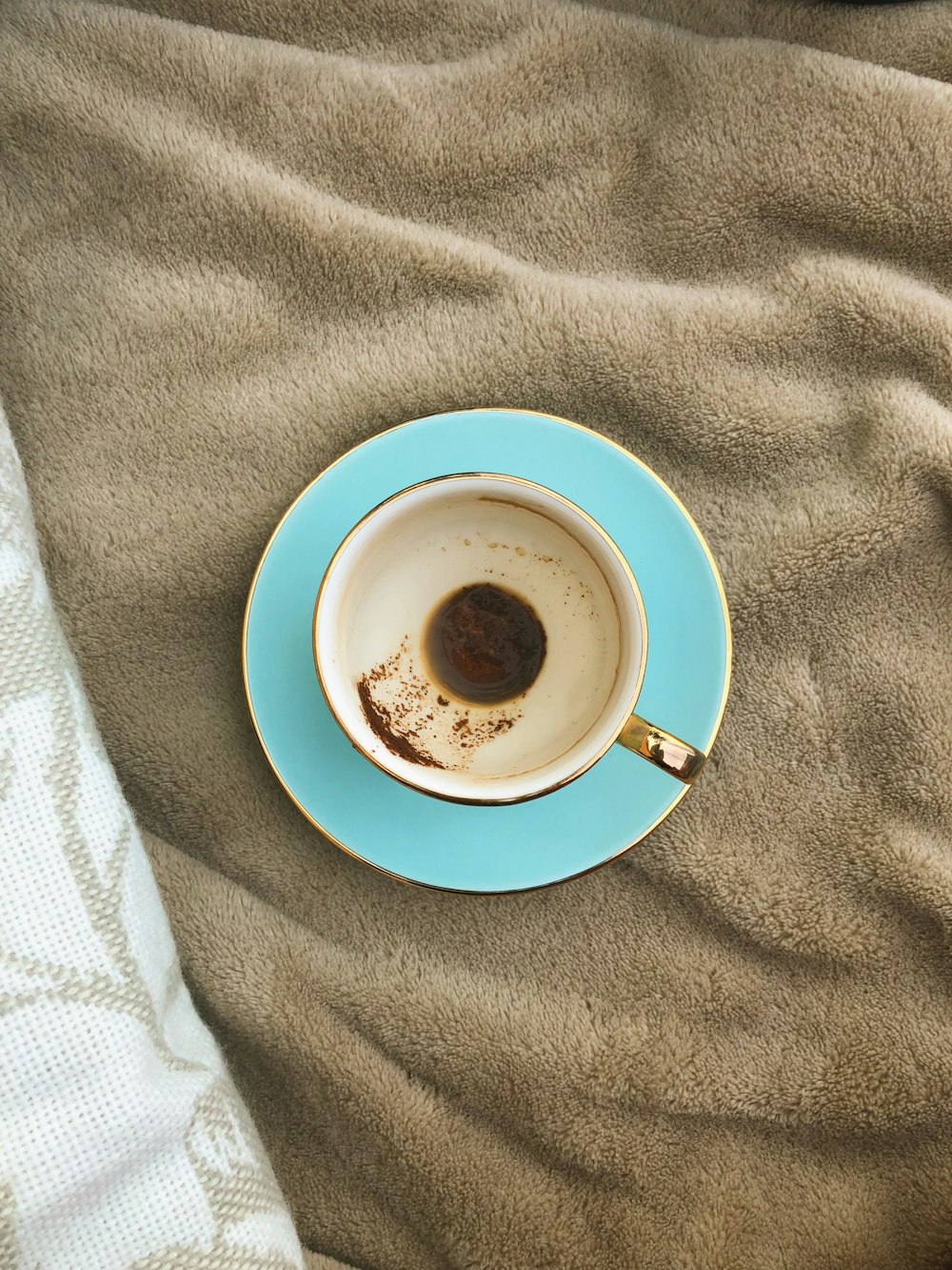 white cup on blue saucer