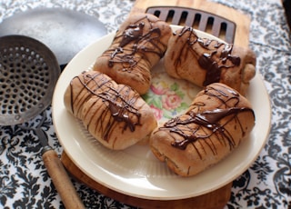 four breads with chocolate syrup on plate