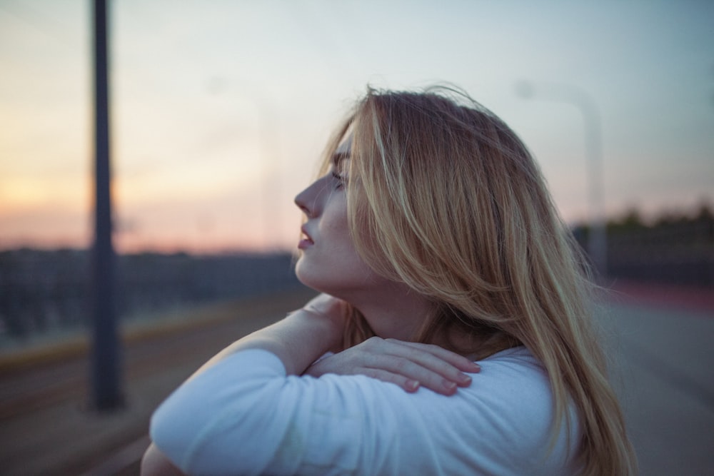 woman wearing white long-sleeved shirt