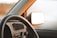 Close-up of a clean car dashboard with sunlight highlighting the polished surfaces.
