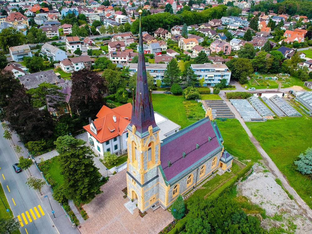 an aerial view of a church in a small town