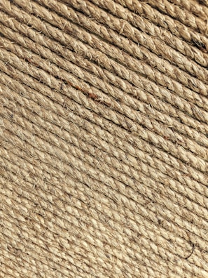 Close-up of thick natural fibre rope coils stacked neatly in a workshop.