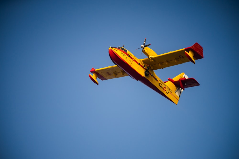 brown airplane flying during daytime