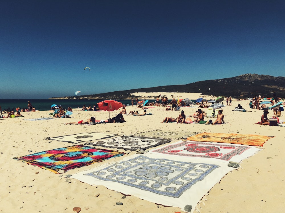 landscape photography of people in white sand beach