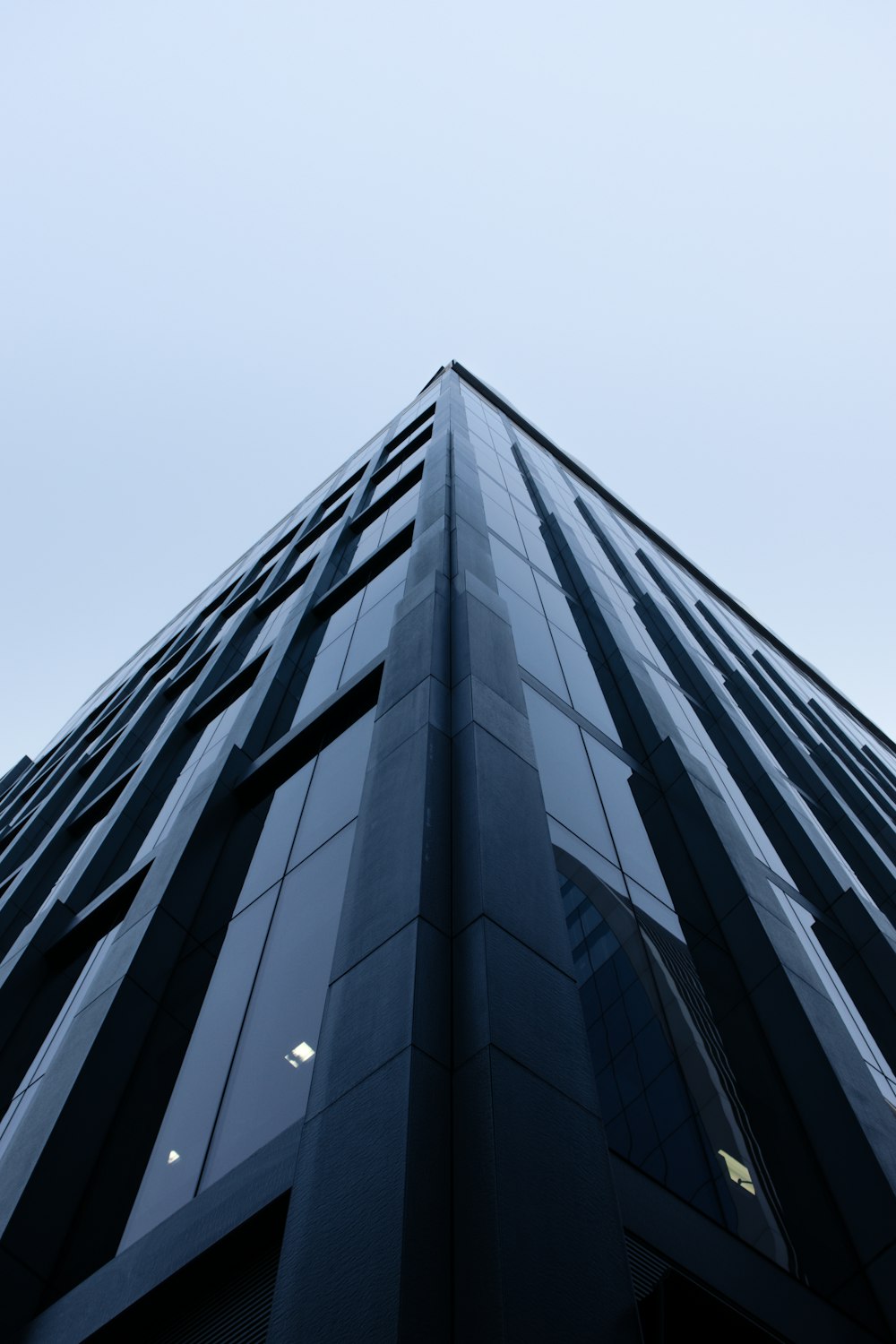 low-angle photography of gray glass walled building