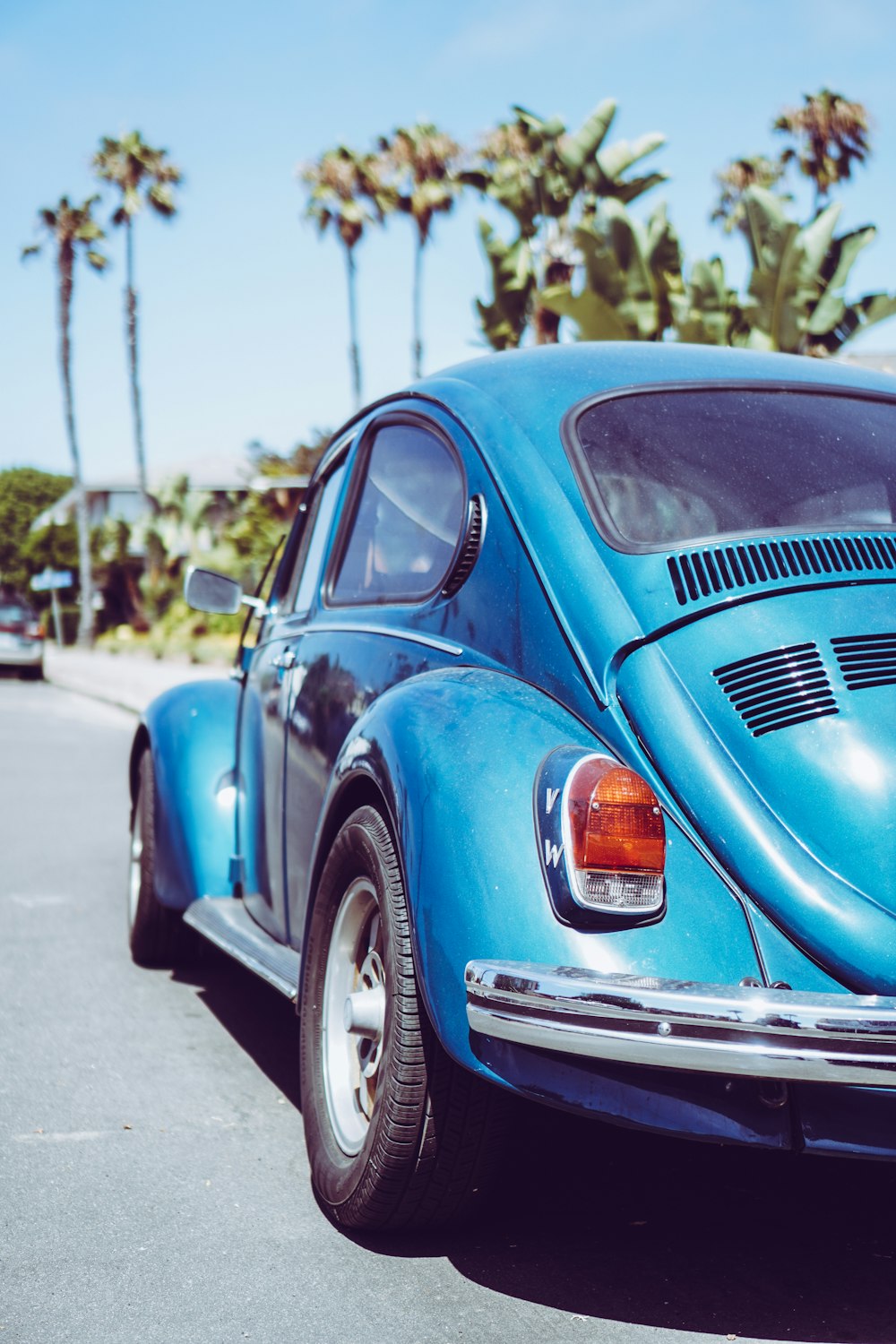 a blue car parked on the side of the road