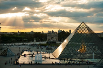 a large pyramid with a fountain in front of it
