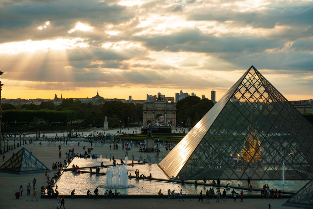 a large pyramid with a fountain in front of it