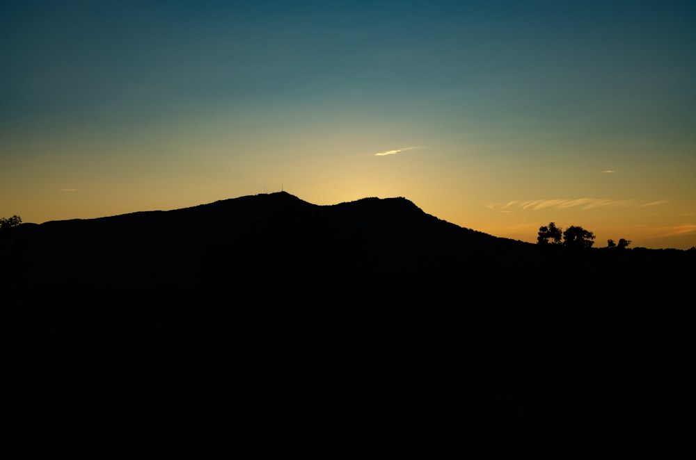 silhouette of mountain at golden hour