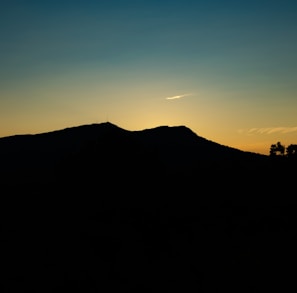 silhouette of mountain at golden hour