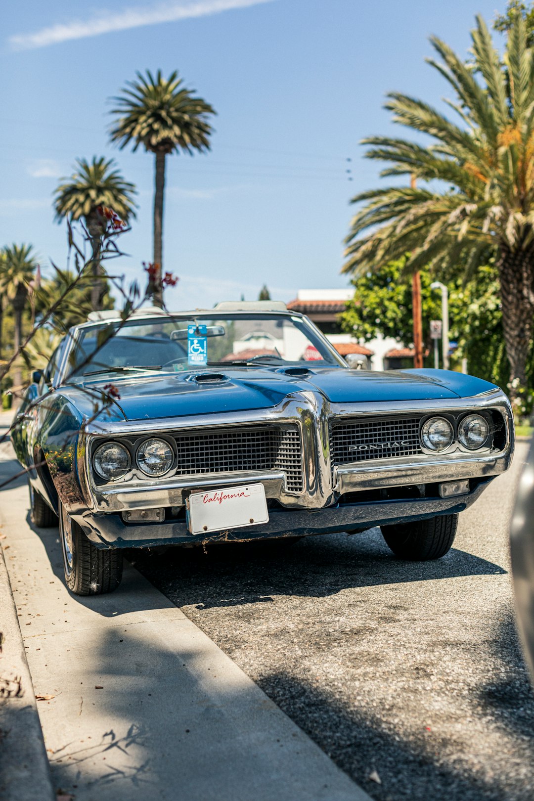 classic blue convertible coupe parked beside road