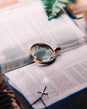 A simple illustration of a document with a magnifying glass symbolizing careful review.