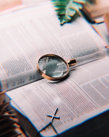 A simple illustration of a document with a magnifying glass symbolizing careful review.