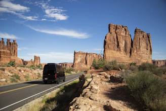 The shuttle van cruising down a palm-lined street under a bright blue sky in Las Vegas.