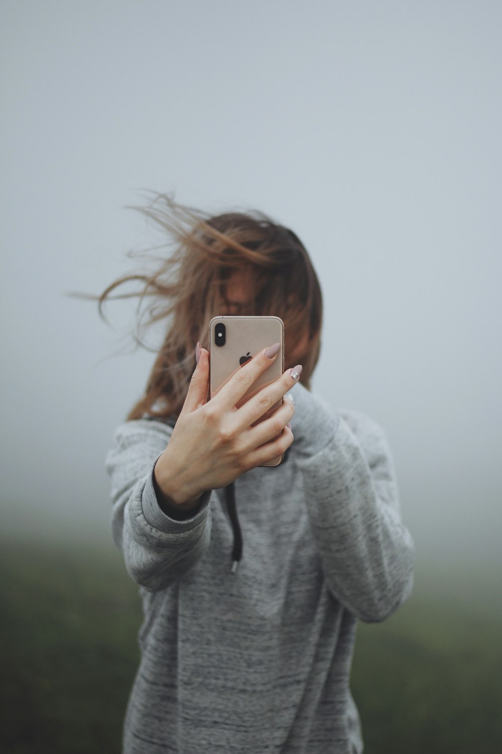 woman holding iPhone smartphone