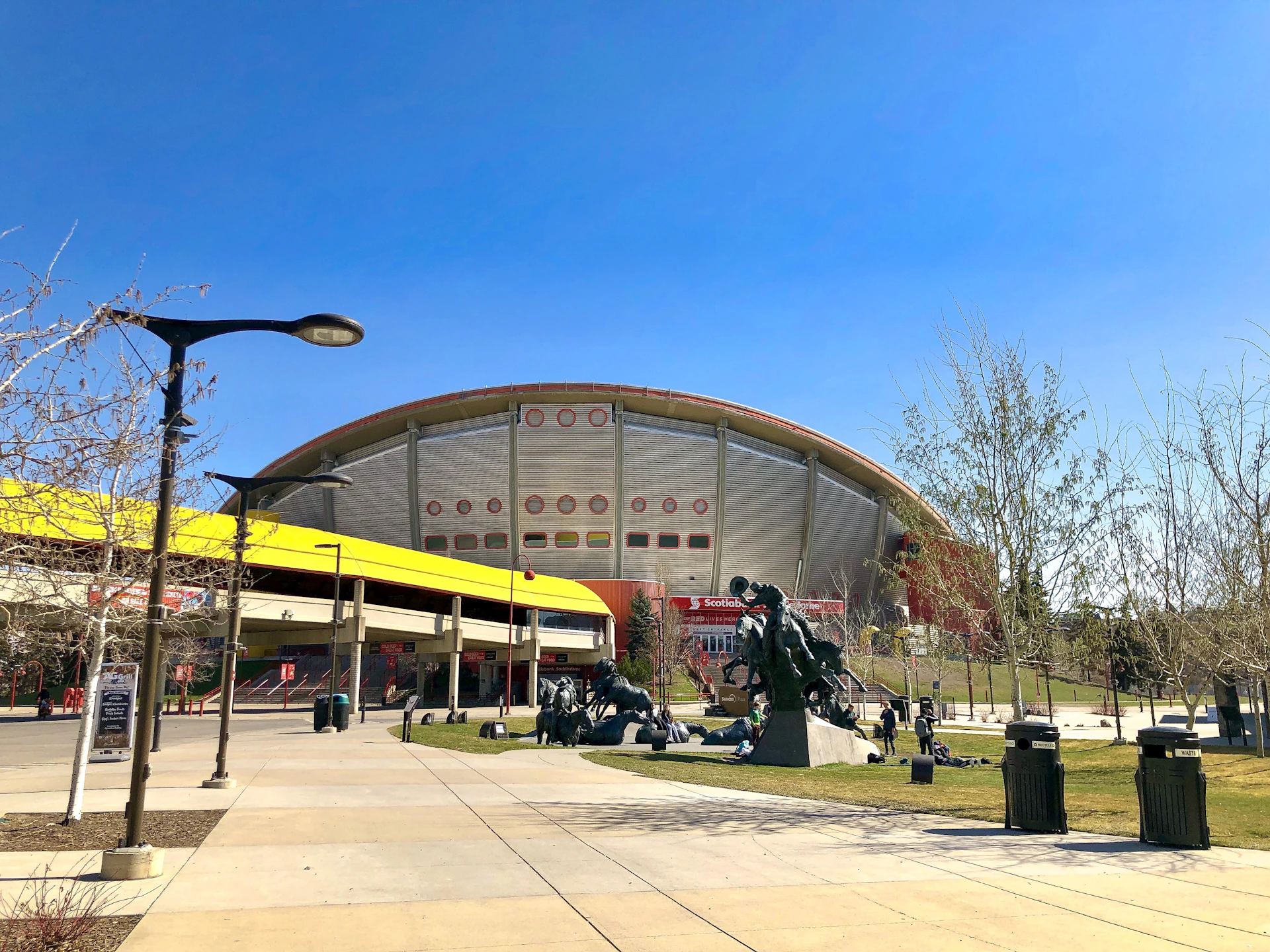 woman wearing yellow long-sleeved dress under white clouds and blue sky during daytime