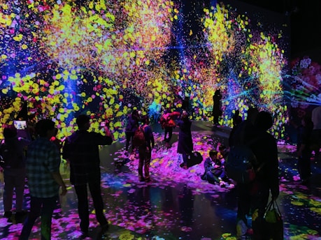Attendees interacting with a vibrant digital installation at a tech event.